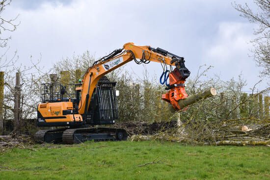 Excavator with tree saw attachment tree cutting