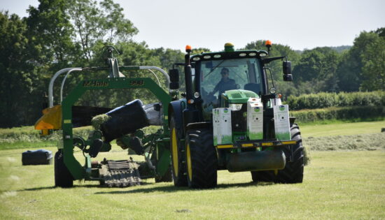 John Deere tractor with McHale bale wrapper