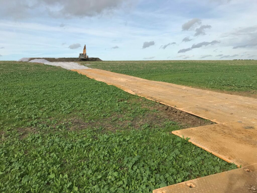 Temporary Trackway boards set out across a field