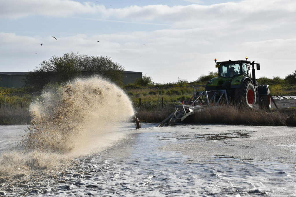 Claas tractor with lagoon stirrer